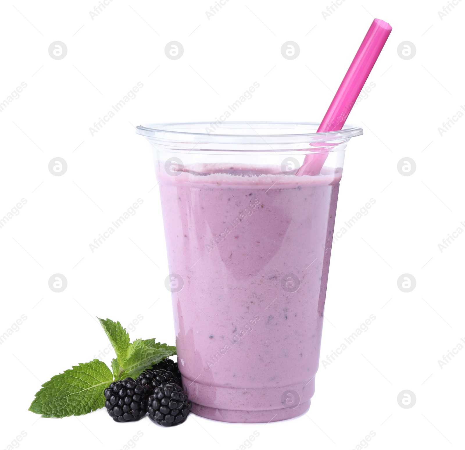 Photo of Tasty fresh milk shake in plastic cup and blackberries on white background