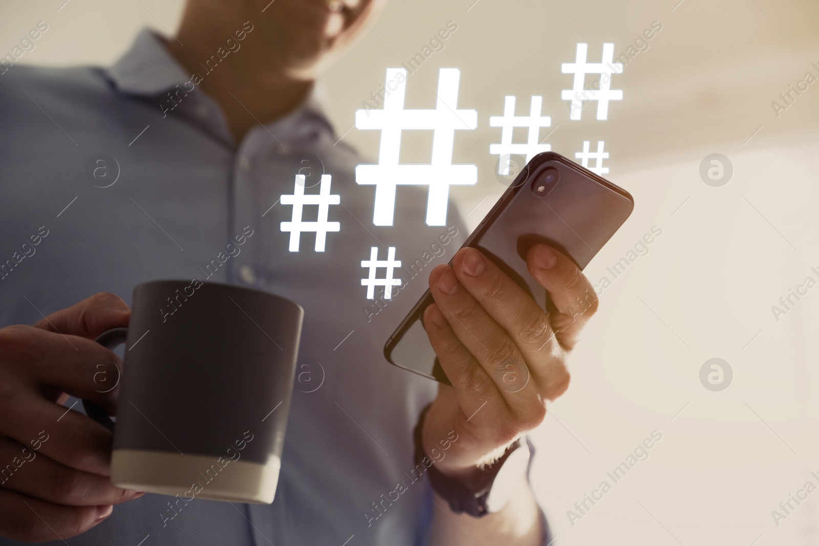 Image of Man with cup of drink using modern smartphone, closeup. Hashtag symbols over device