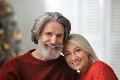 Photo of Happy mature couple celebrating Christmas at home
