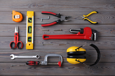 Flat lay composition with different construction tools on wooden background