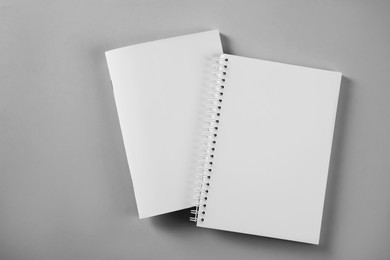Photo of Blank brochure and notebook on grey background, flat lay. Mockup for design