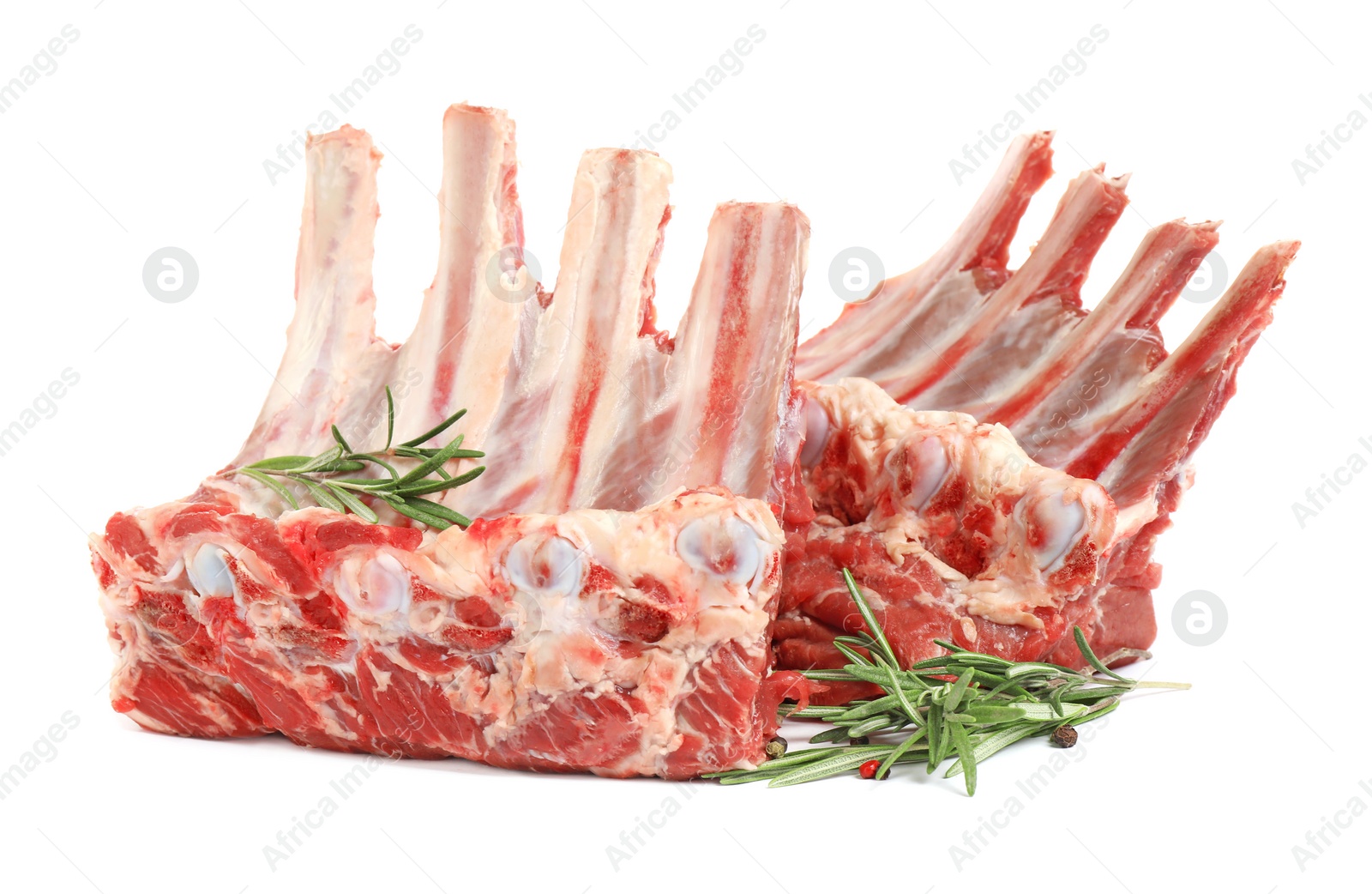 Photo of Raw ribs with rosemary and pepper on white background