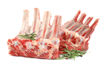 Photo of Raw ribs with rosemary and pepper on white background