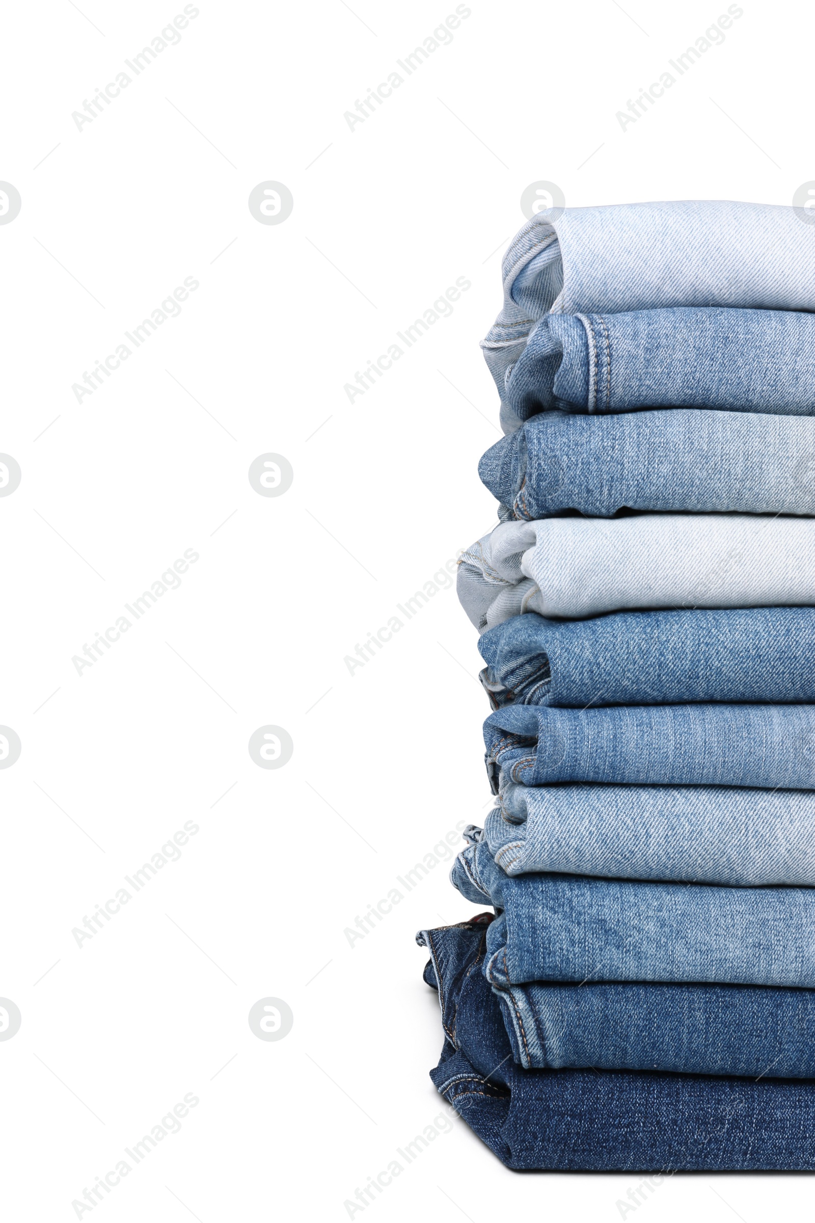 Image of Stack of different folded jeans isolated on white