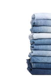 Stack of different folded jeans isolated on white