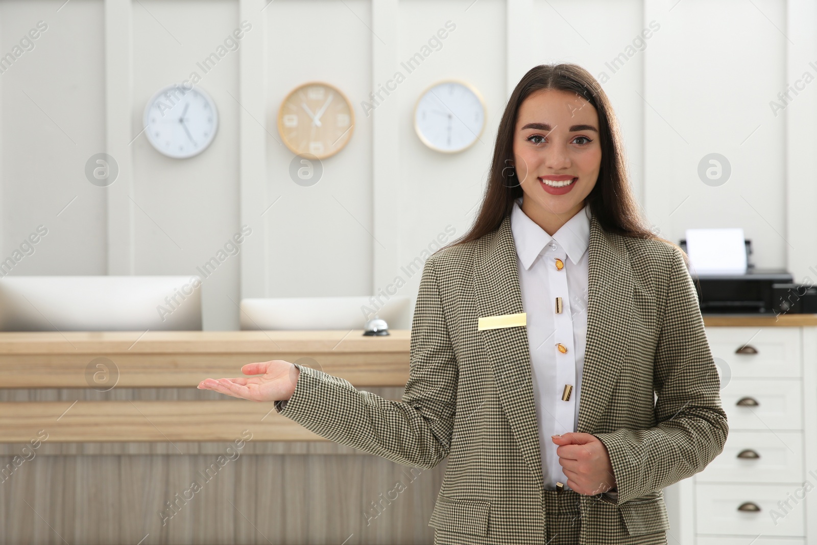 Photo of Portrait of beautiful receptionist near counter in hotel