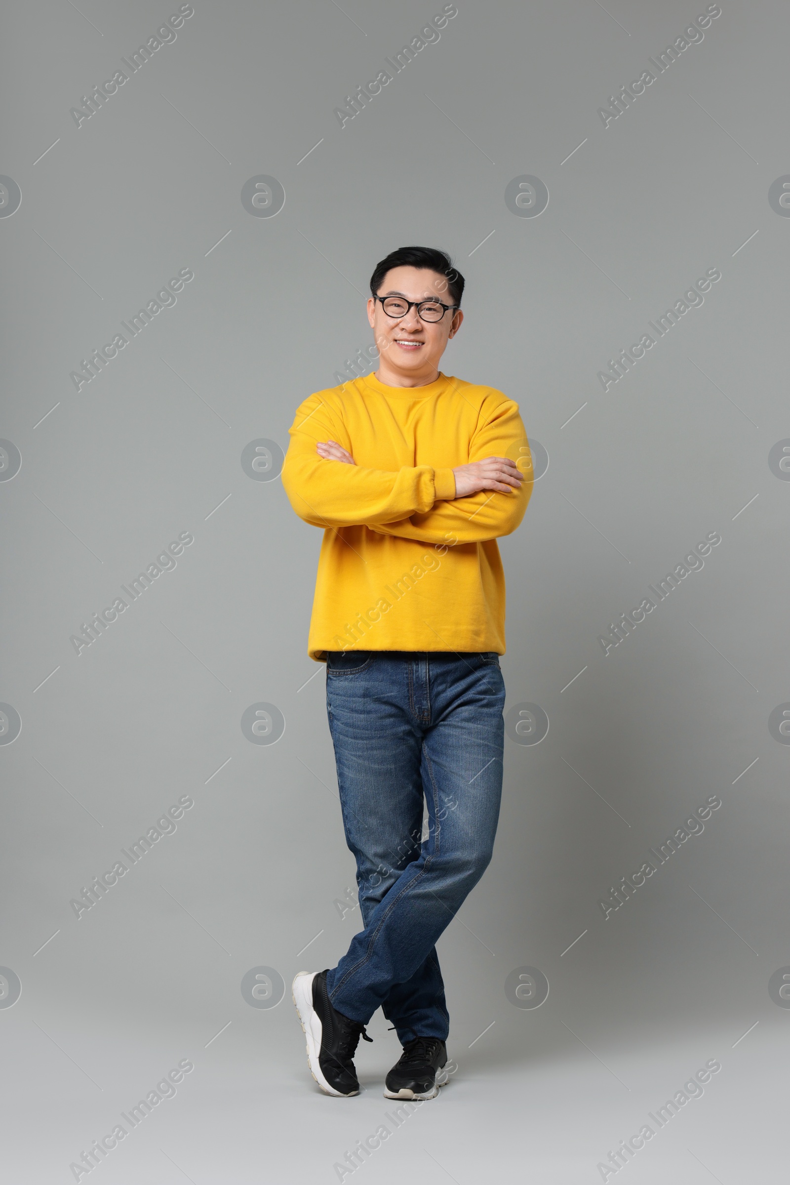 Photo of Full length portrait of happy man on grey background