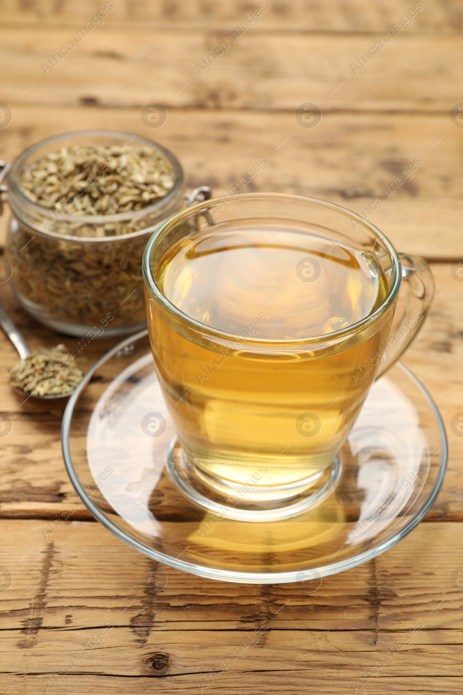 Photo of Aromatic fennel tea and seeds on wooden table