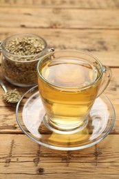 Aromatic fennel tea and seeds on wooden table