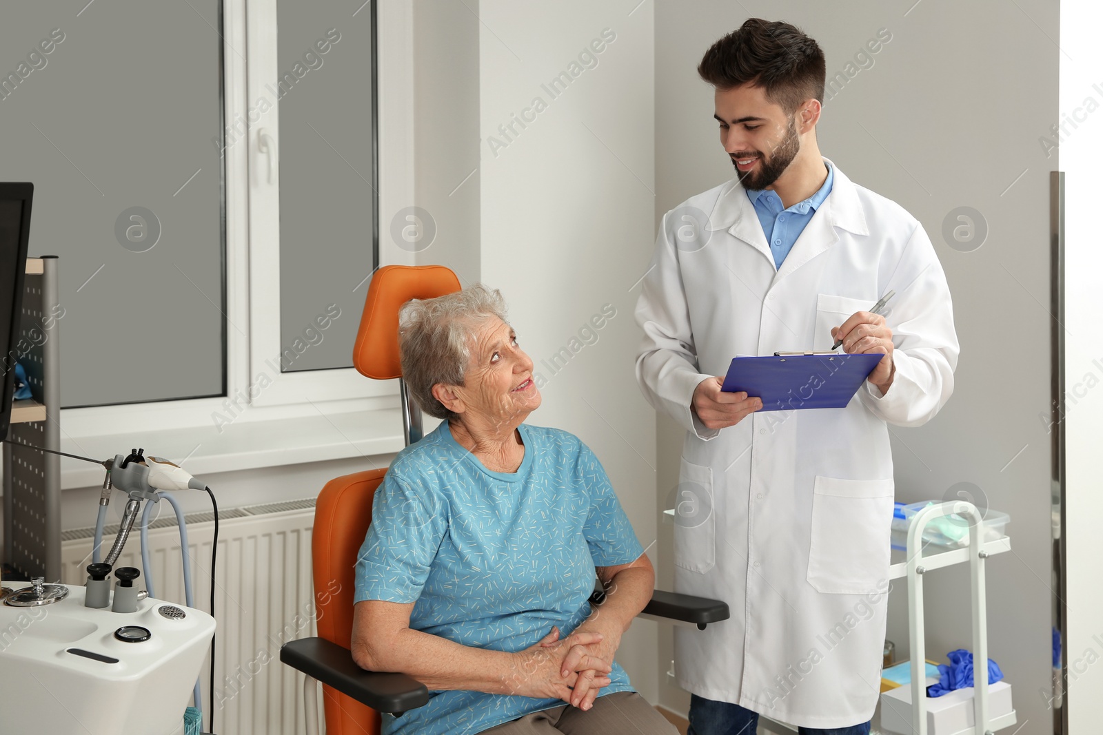 Photo of Senior woman visiting otolaryngologist in clinic. Hearing aid