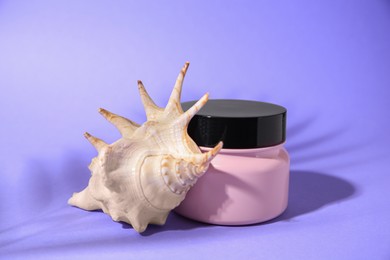 Hair mask and seashell on violet background