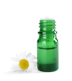 Photo of Bottle of herbal essential oil and chamomile flower isolated on white