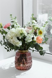 Photo of Bouquet of beautiful flowers on windowsill indoors