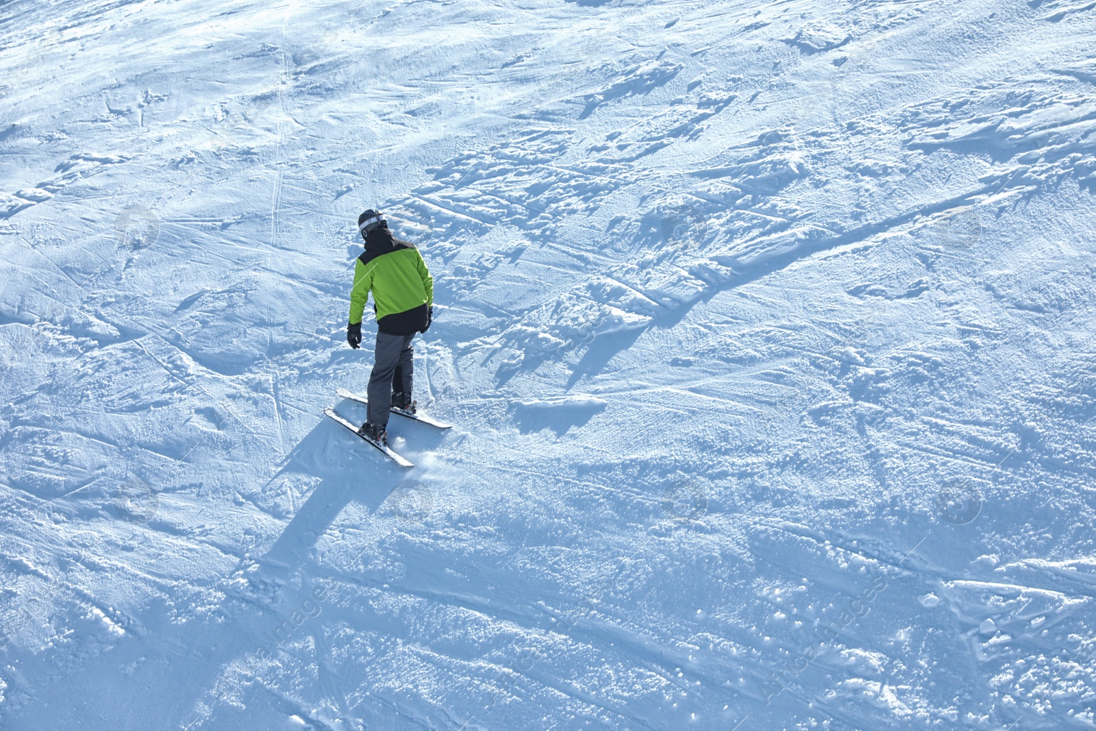 Photo of Male skier on slope at resort. Winter vacation