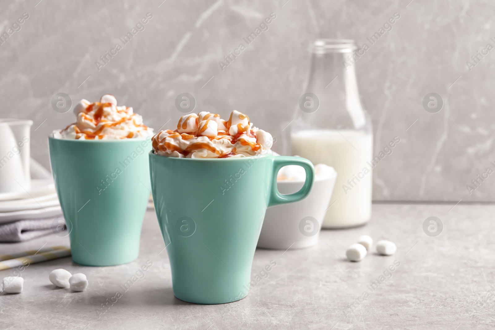 Photo of Cups with delicious caramel frappe on table