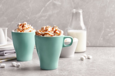 Photo of Cups with delicious caramel frappe on table