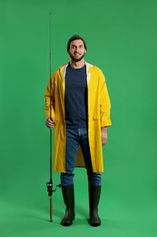 Photo of Fisherman with fishing rod on green background