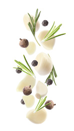 Image of Set of falling garlic cloves and other seasonings on white background
