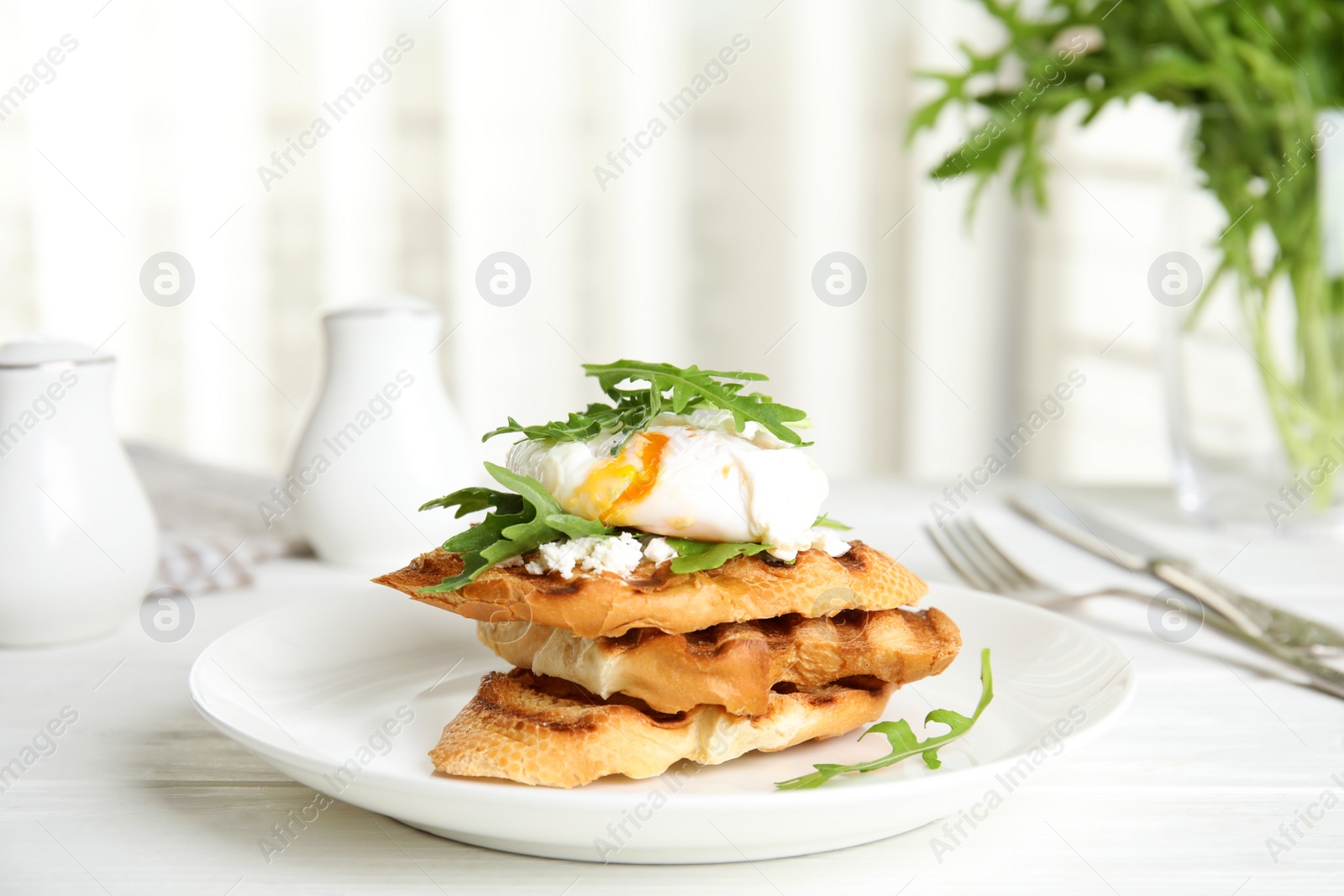 Photo of Delicious sandwich with arugula and egg on white wooden table