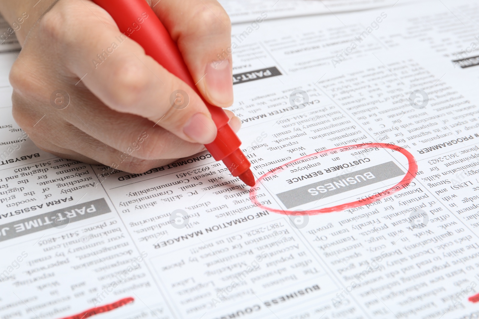 Photo of Woman marking advertisement in newspaper, closeup. Job search concept