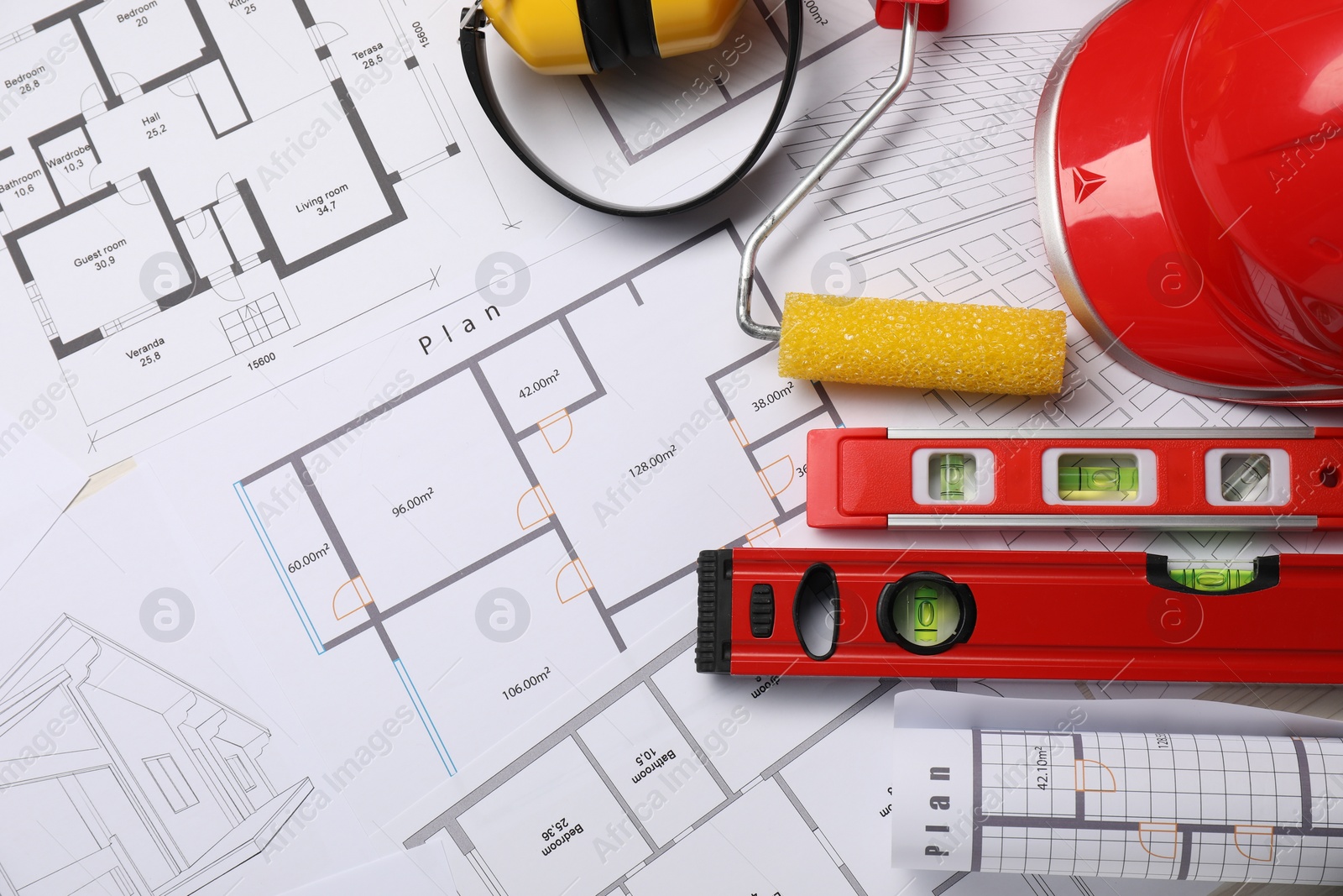 Photo of Flat lay composition with building level and other construction tools on papers