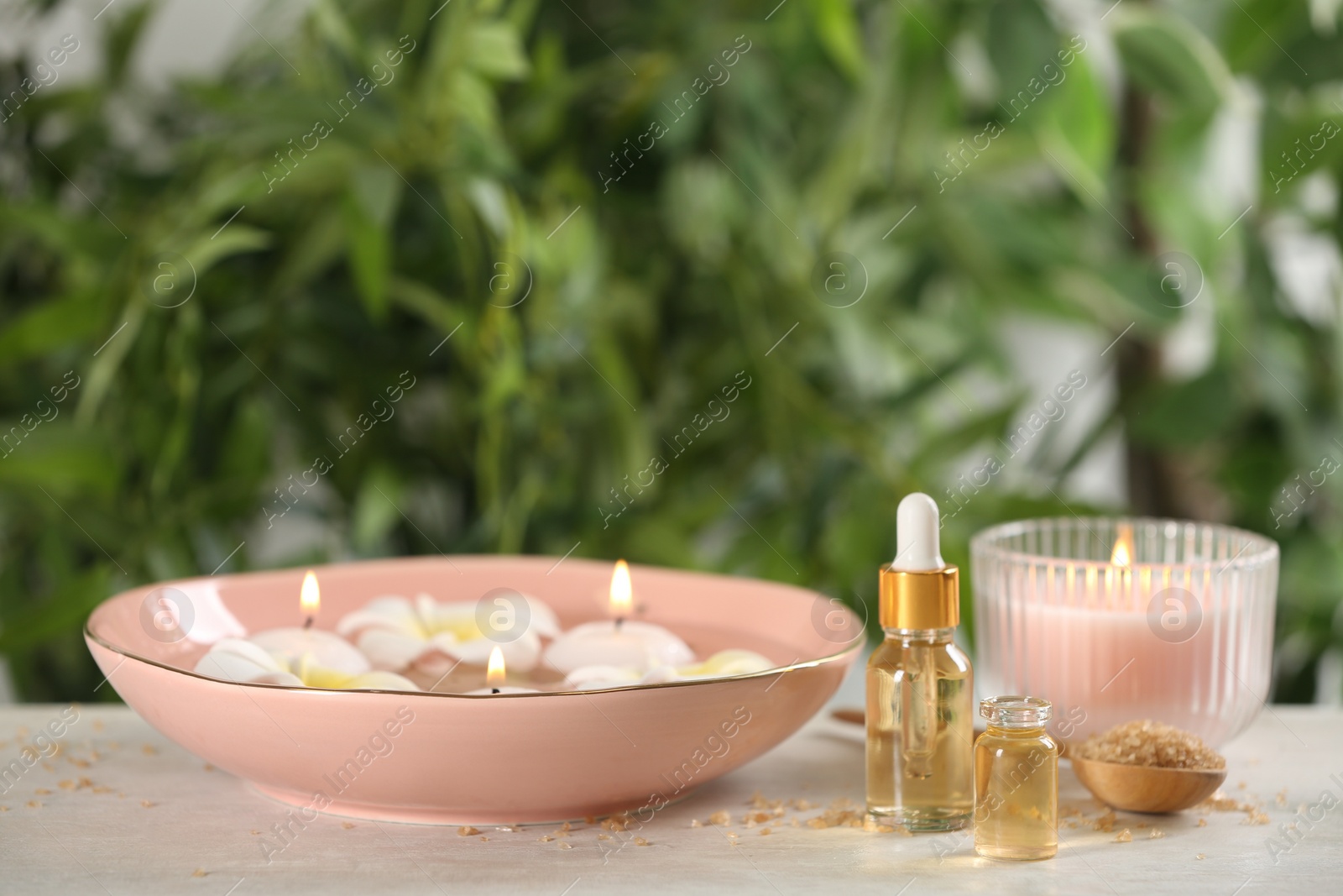 Photo of Beautiful spa composition with aroma oil and candles on table
