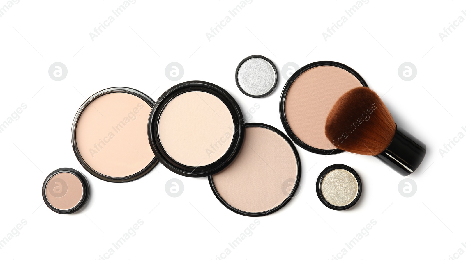 Photo of Flat lay composition with different makeup face powders on white background