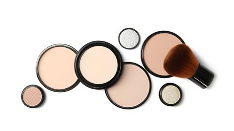 Photo of Flat lay composition with different makeup face powders on white background