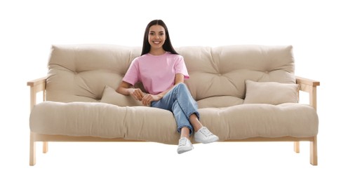 Young woman relaxing on comfortable sofa against white background