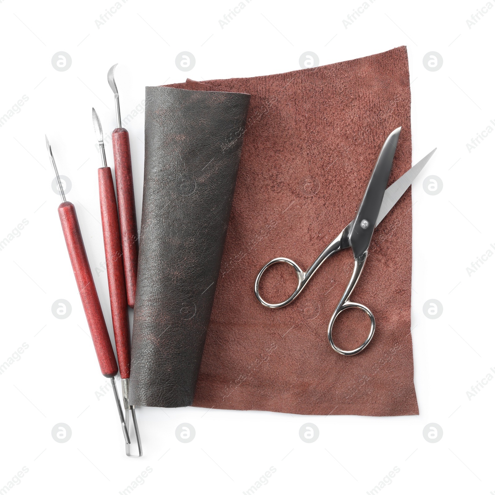 Photo of Leather sample and craftsman tools isolated on white, top view