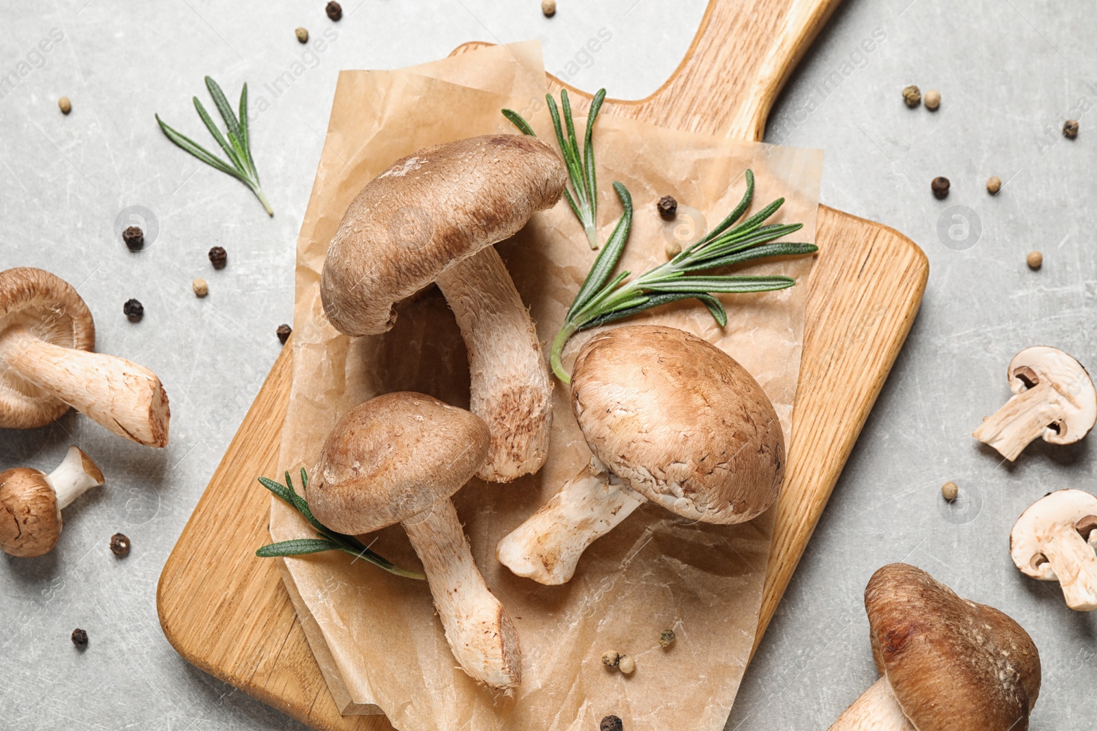 Photo of Flat lay composition with fresh wild mushrooms on light grey table