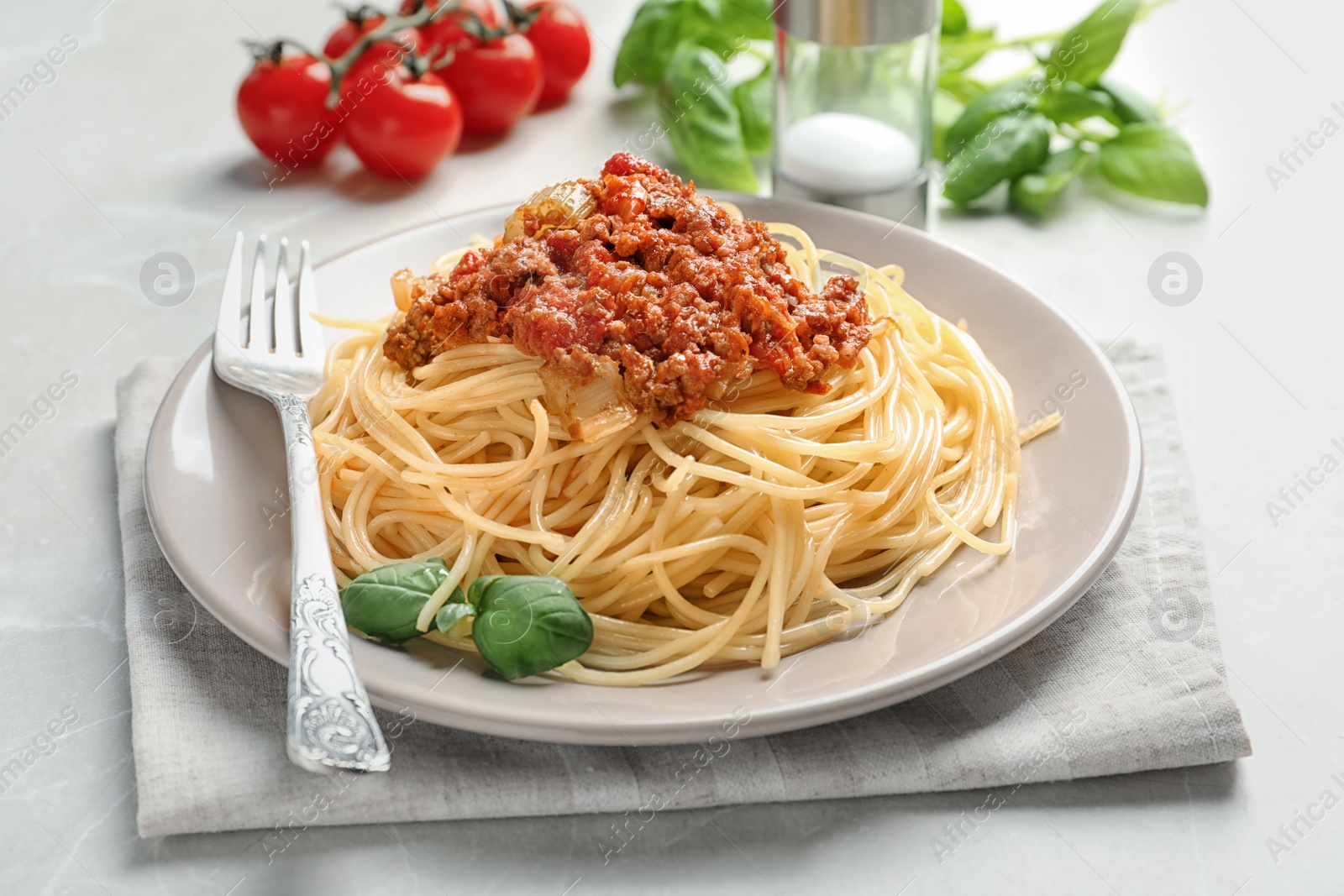 Photo of Plate with delicious pasta bolognese on table