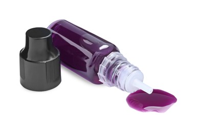 Bottle of purple food coloring on white background