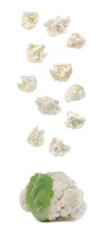 Many fresh cauliflower florets falling on white background