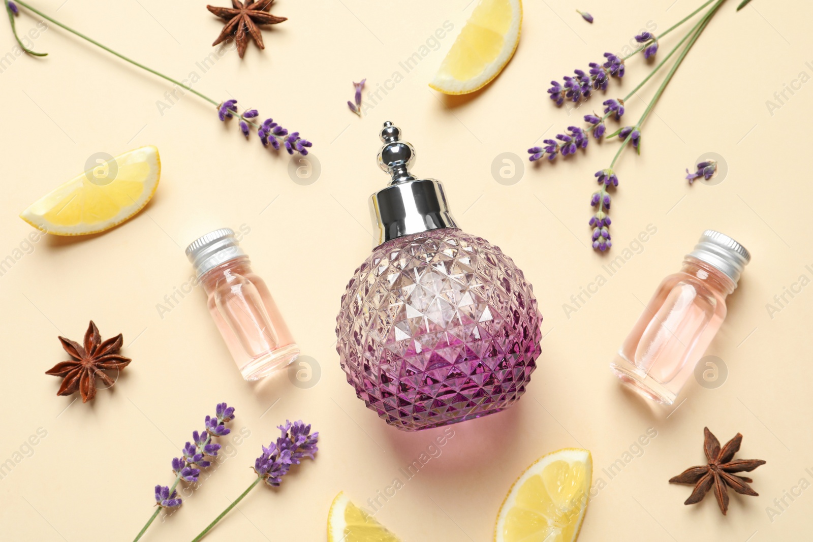 Photo of Flat lay composition with elegant perfume on beige background