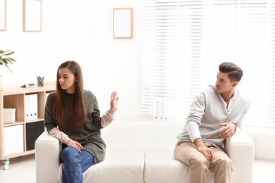 Emotional couple on sofa in psychologist's office