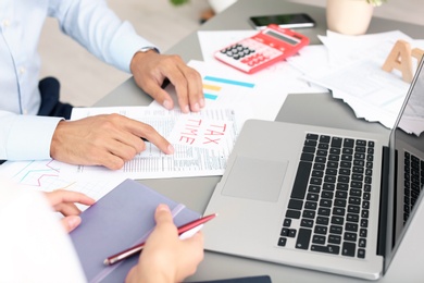 Tax accountants working with documents at table