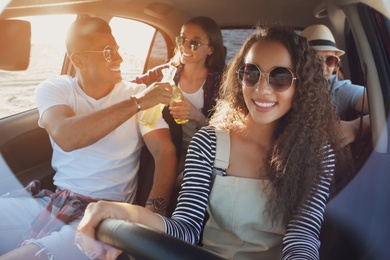 Photo of Happy friends together in car on road trip