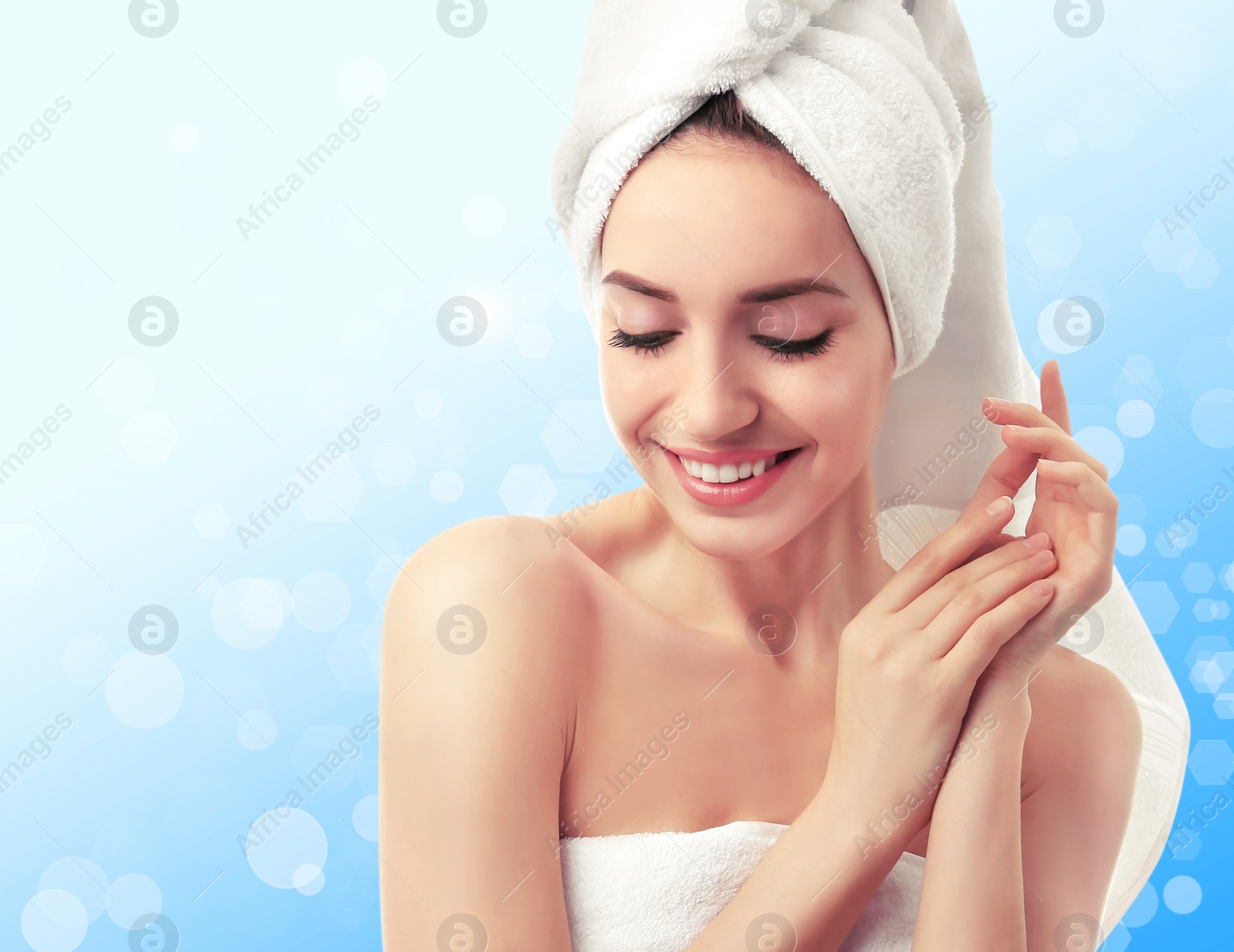 Image of Beautiful young woman with silky skin on light background. Spa treatment 