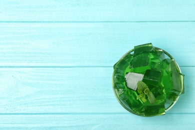 Bowl of tasty jelly on table, top view with space for text