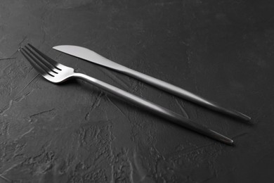 Photo of Set of beautiful cutlery on black table