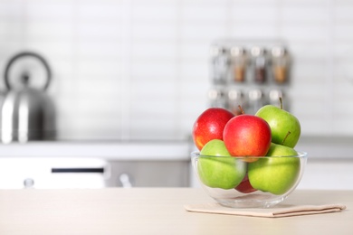 Photo of Bowl of fresh apples on kitchen counter. Space for text