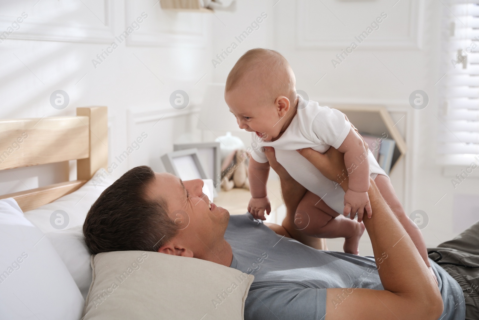 Photo of Father with his cute baby at home. Happy family