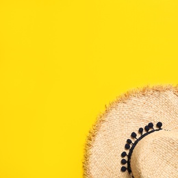 Stylish straw hat on color background, top view with space for text. Beach accessories