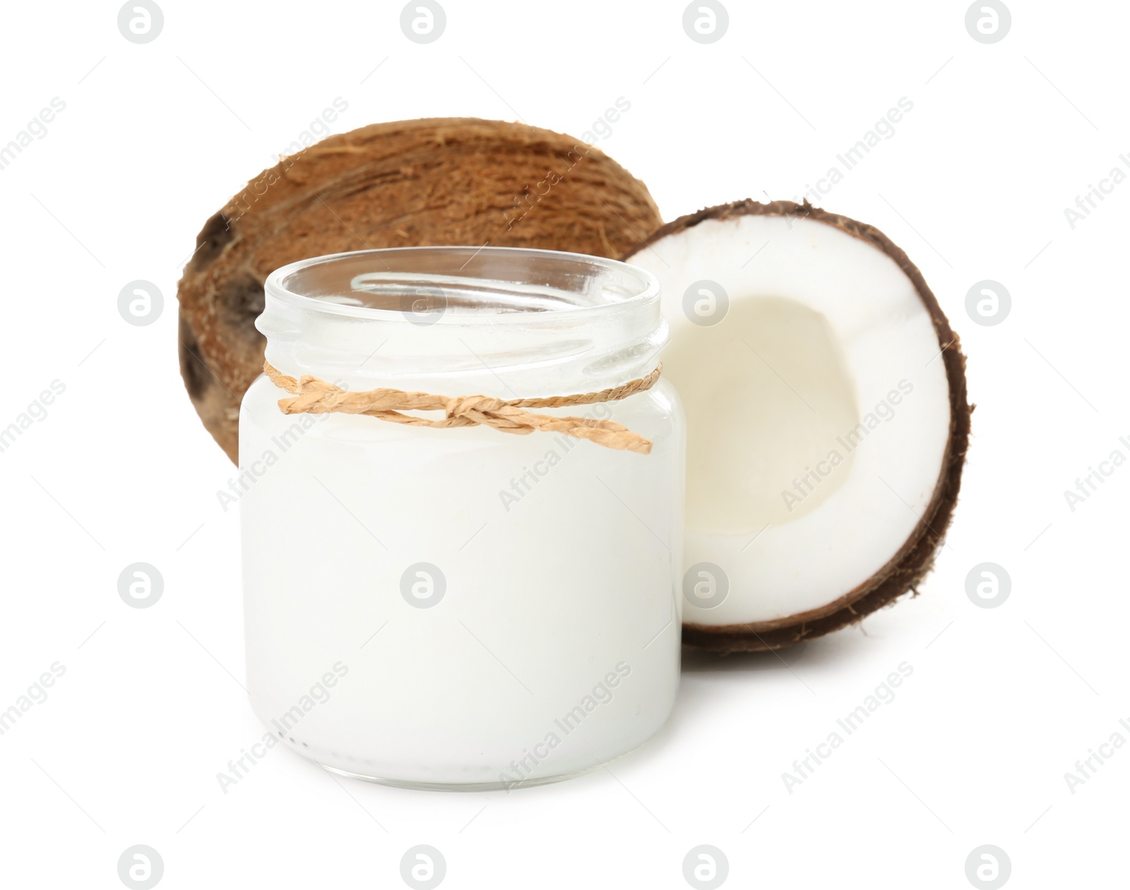 Photo of Ripe coconuts and jar with organic oil on white background. Healthy cooking