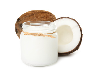 Photo of Ripe coconuts and jar with organic oil on white background. Healthy cooking