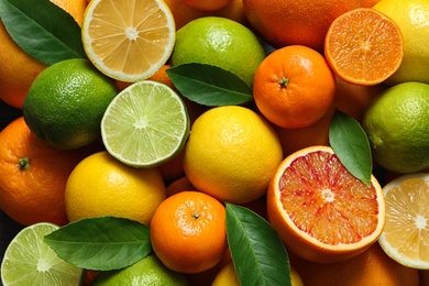 Photo of Many different citrus fruits as background, top view