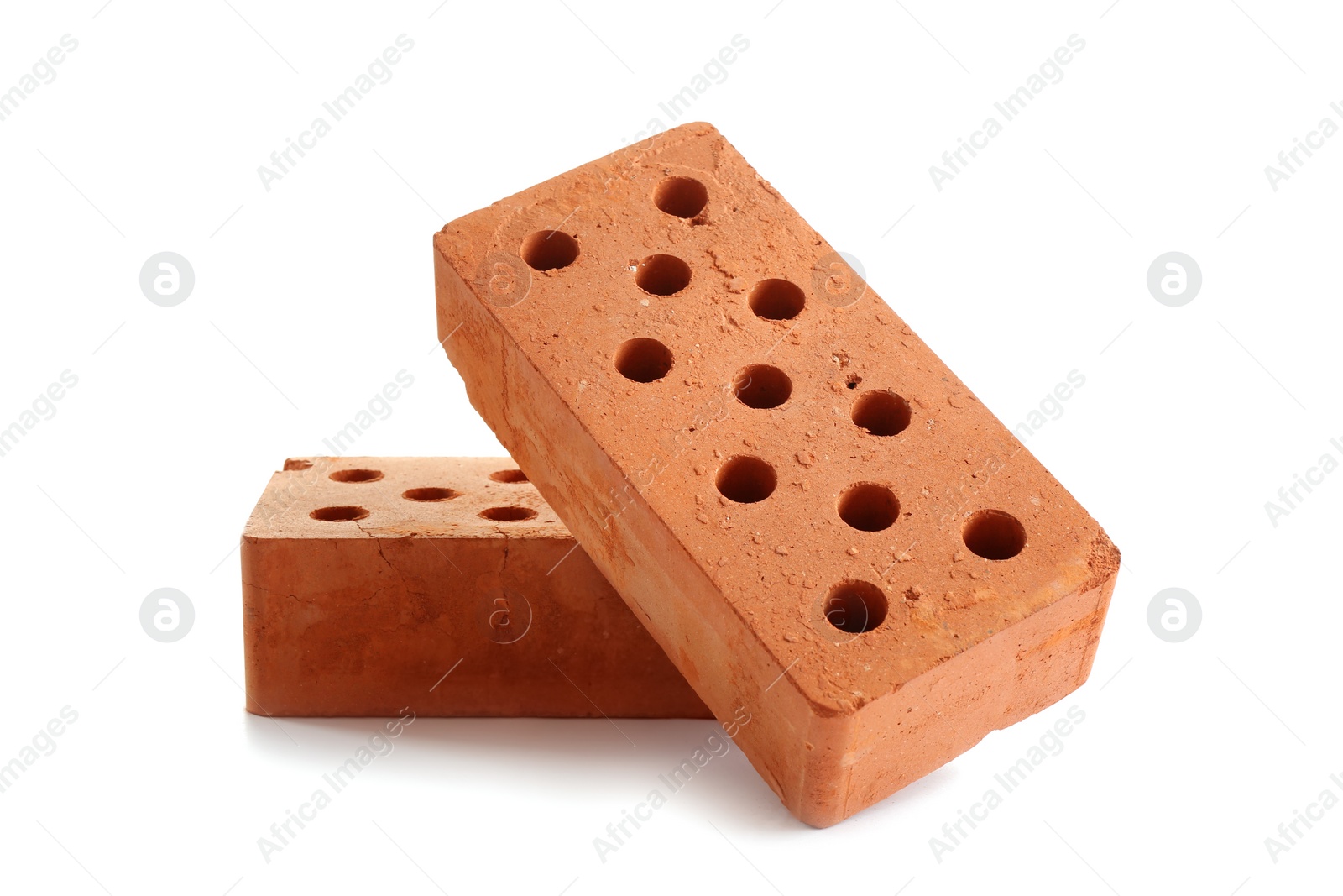 Photo of New cored bricks on white background. Construction industry