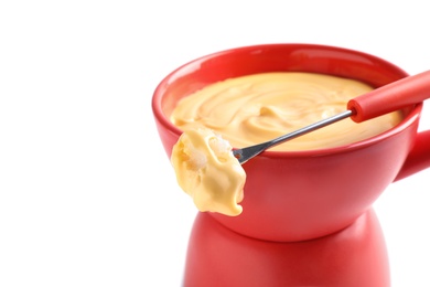 Photo of Pot of delicious cheese fondue and fork with bread on white background, closeup