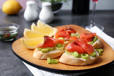 Sandwiches with fresh sliced salmon fillet on plate, closeup